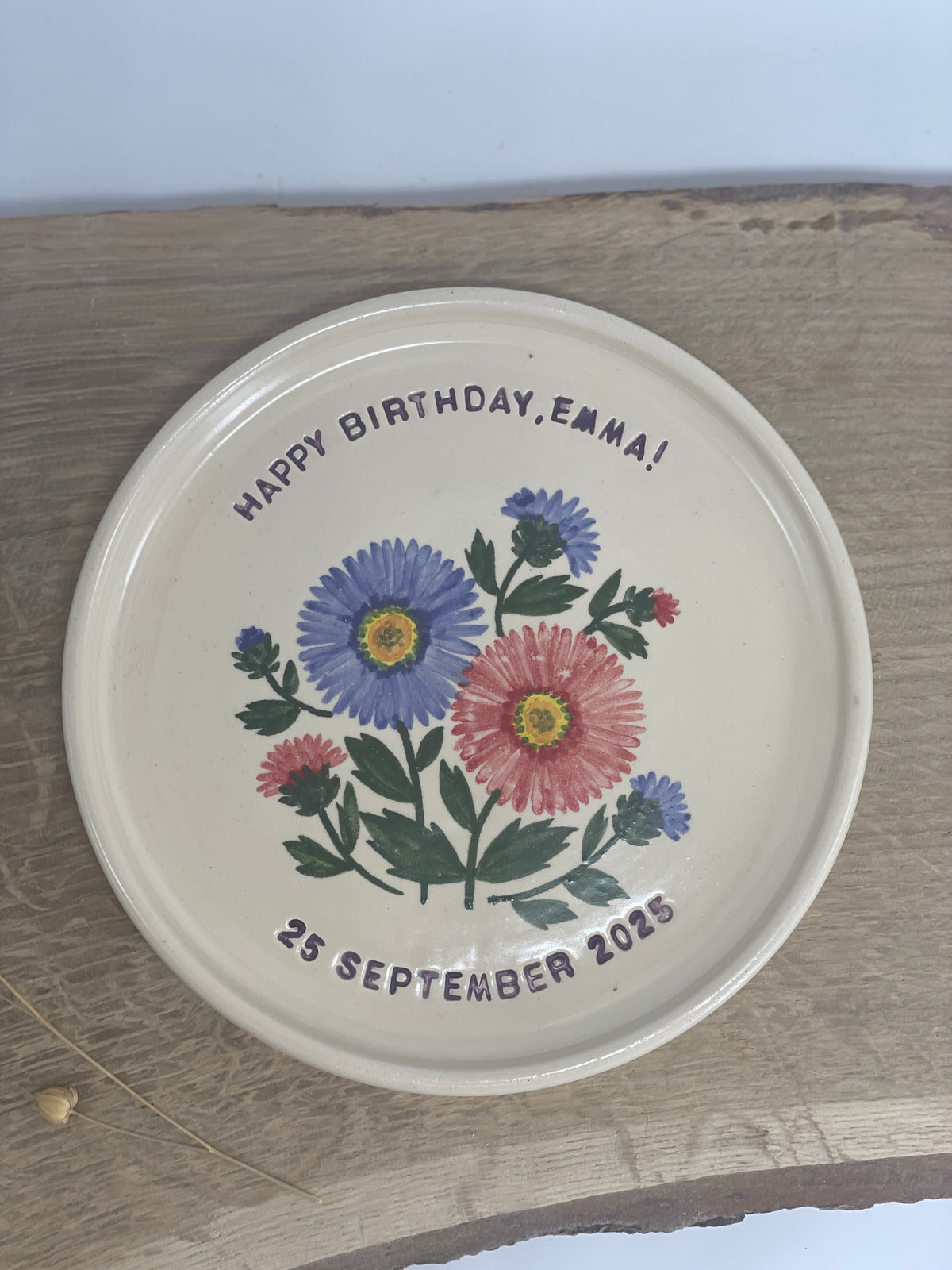 A hand-painted ceramic happy birthday plate